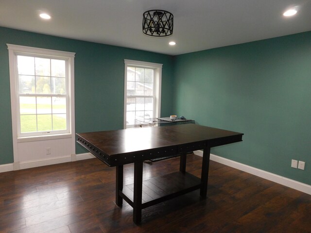 dining space with dark wood-style floors, plenty of natural light, and baseboards