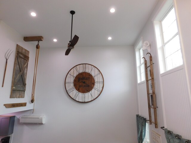 interior details featuring a wall unit AC and recessed lighting