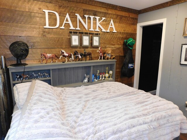 bedroom with wooden walls