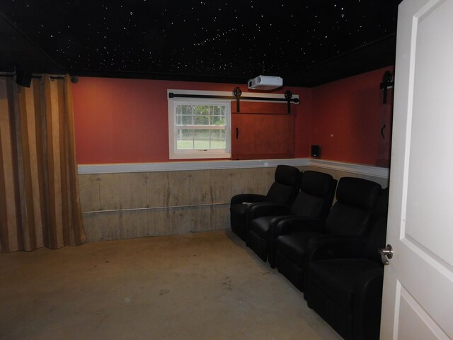 home theater room featuring wainscoting