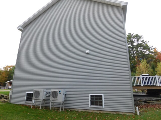 view of side of home with ac unit and a deck