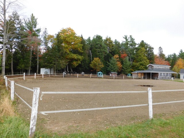 view of property's community featuring an enclosed area and fence