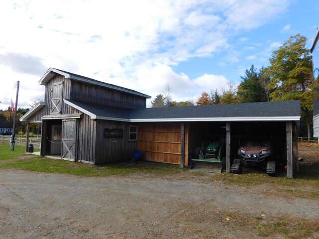 view of barn featuring a carport