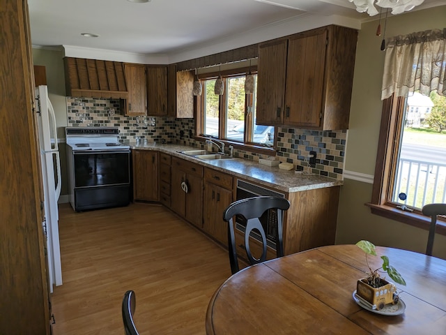 kitchen with tasteful backsplash, white fridge, sink, and electric range