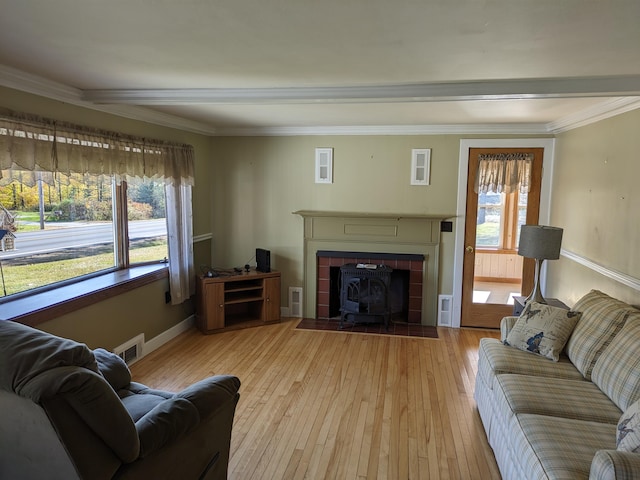 living room with crown molding, plenty of natural light, and light hardwood / wood-style floors