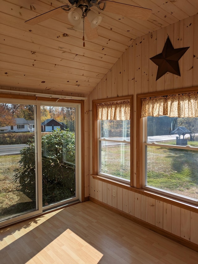 unfurnished sunroom featuring wood ceiling and lofted ceiling