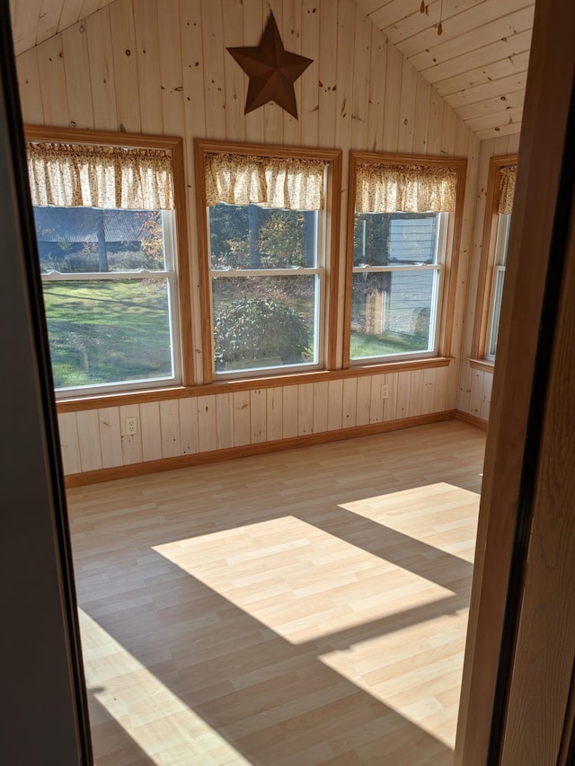 unfurnished sunroom featuring lofted ceiling and wood ceiling