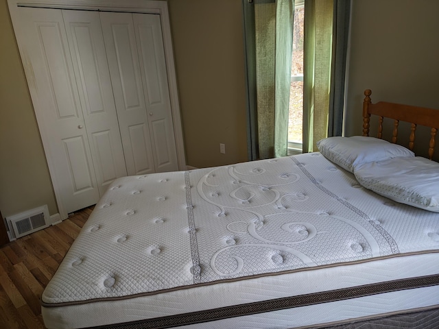 bedroom with hardwood / wood-style flooring and a closet