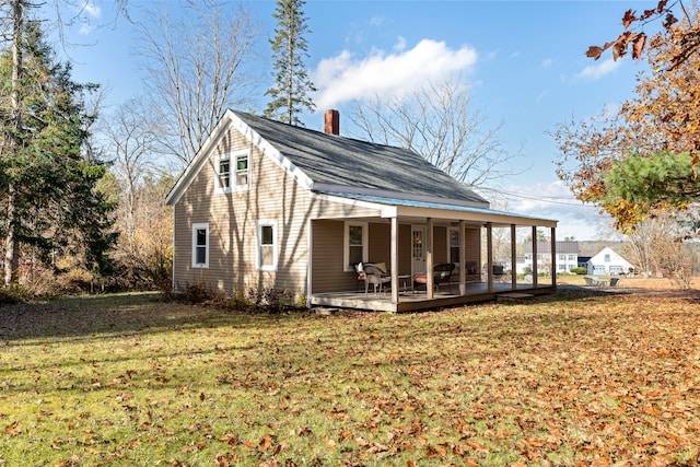 back of house with a yard