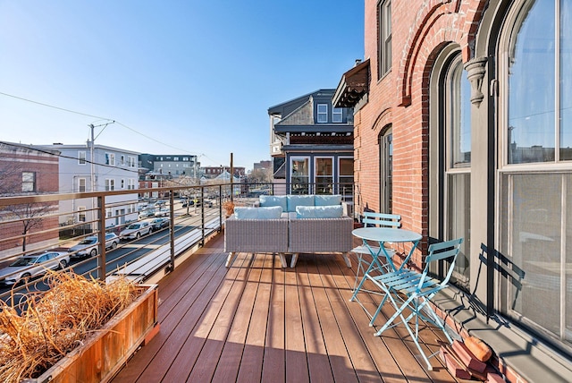 wooden terrace featuring outdoor lounge area