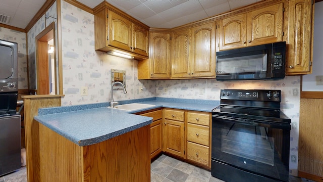 kitchen with sink, black appliances, and crown molding