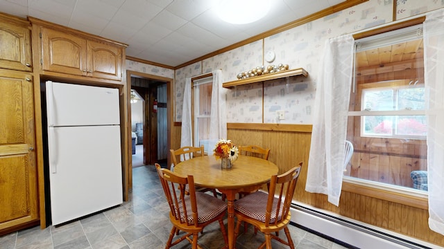 dining space with ornamental molding and a baseboard radiator