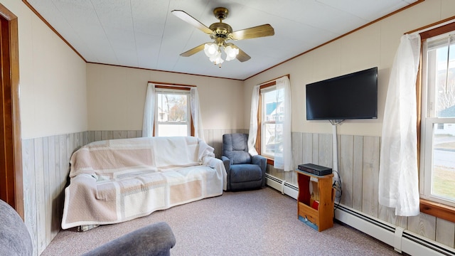 living room with a baseboard radiator, carpet, and ceiling fan