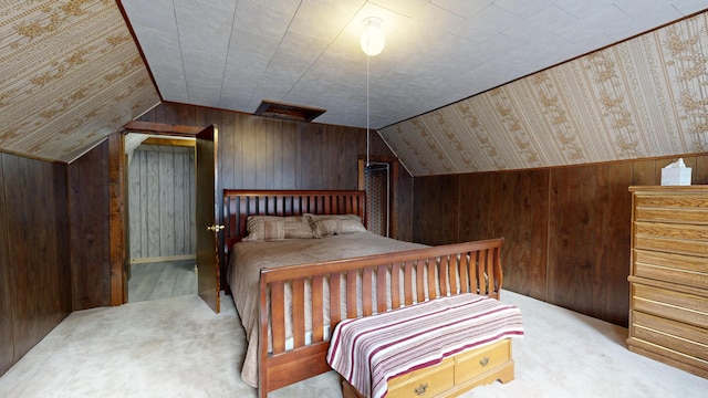 carpeted bedroom featuring lofted ceiling and wood walls