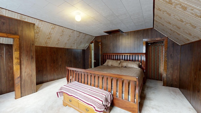 carpeted bedroom featuring wooden walls and vaulted ceiling