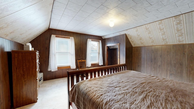 bedroom featuring lofted ceiling, light colored carpet, and wooden walls