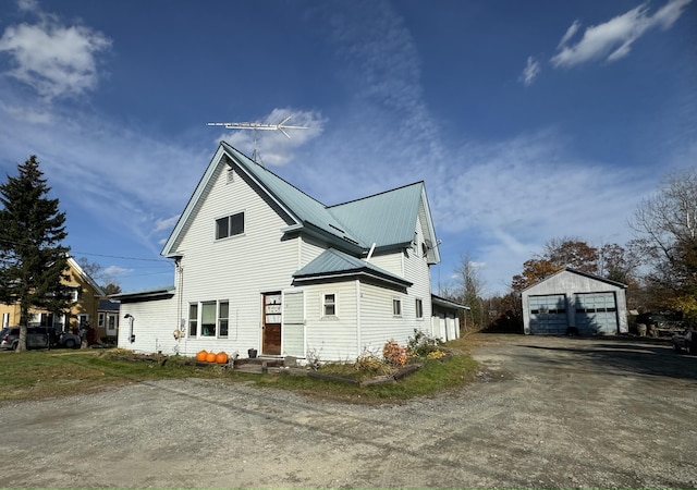 view of side of property with an outdoor structure and a garage