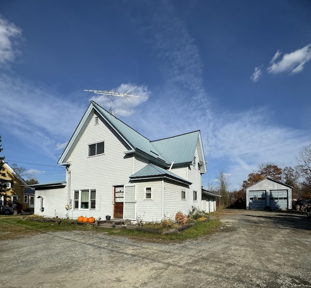 exterior space with a garage and an outdoor structure