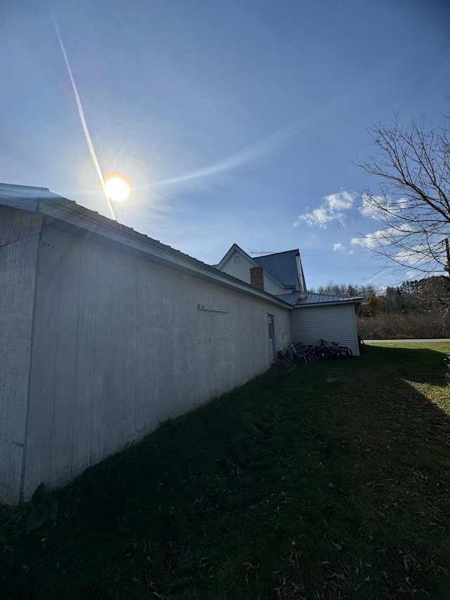 view of side of home featuring a lawn