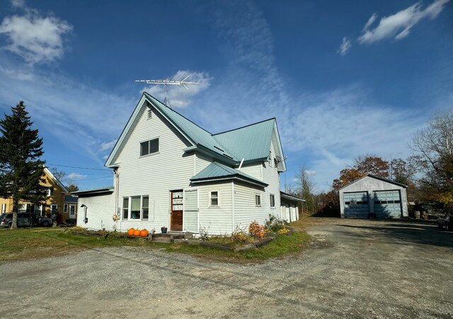 view of side of property featuring an outdoor structure and a garage