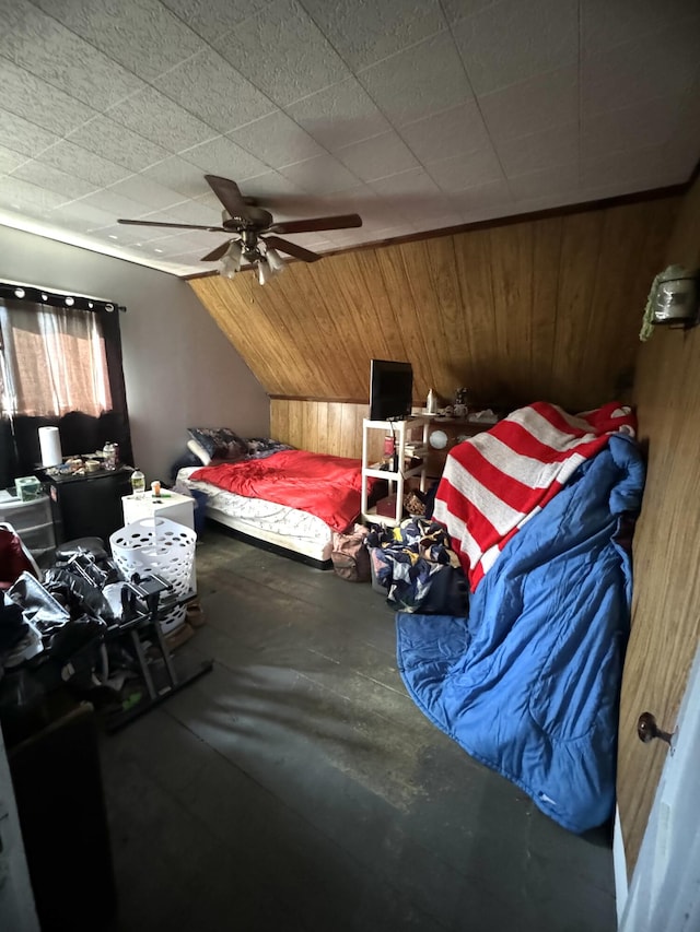 bedroom with ceiling fan, wood walls, lofted ceiling, and concrete flooring