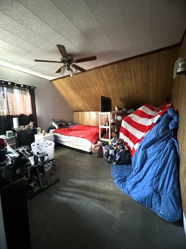 bedroom with ceiling fan, wooden walls, concrete flooring, and vaulted ceiling