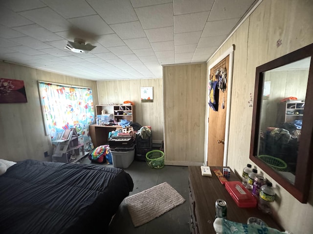 bedroom featuring wood walls