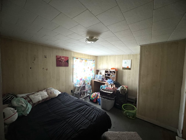 bedroom featuring wooden walls