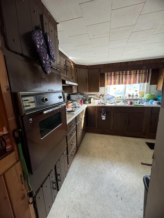 kitchen featuring dark brown cabinets and oven