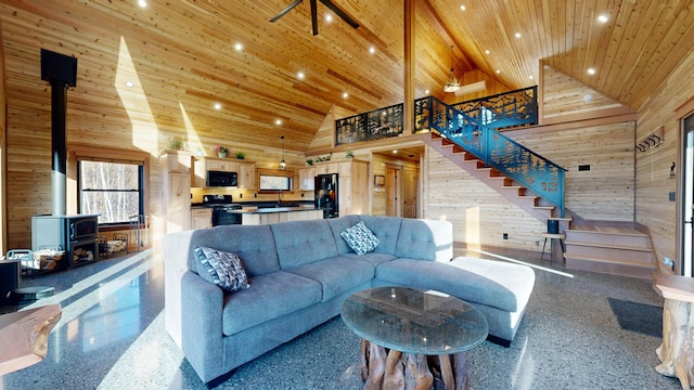 living room with ceiling fan, wooden ceiling, beamed ceiling, high vaulted ceiling, and wooden walls