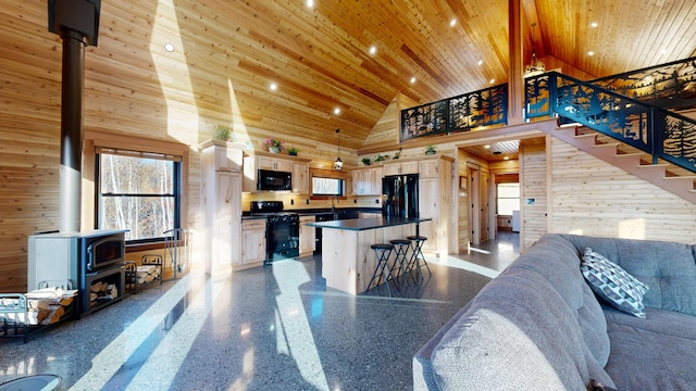 living room featuring a wood stove, high vaulted ceiling, wooden walls, and wood ceiling