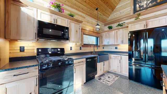 kitchen featuring pendant lighting, lofted ceiling, black appliances, sink, and light brown cabinetry