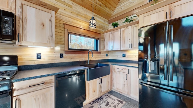 kitchen with sink, decorative light fixtures, vaulted ceiling, light brown cabinetry, and black appliances