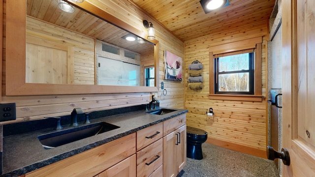 kitchen featuring wooden walls and sink