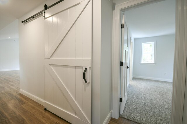 LOT8 Ward Rd, Sebago, ME 04029 - corridor with baseboards, a barn door, and wood finished floors