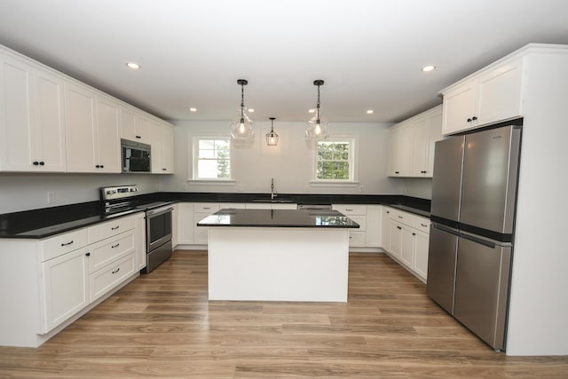 LOT8 Ward Rd, Sebago, ME 04029 - kitchen featuring stainless steel appliances, dark countertops, white cabinetry, a kitchen island, and recessed lighting