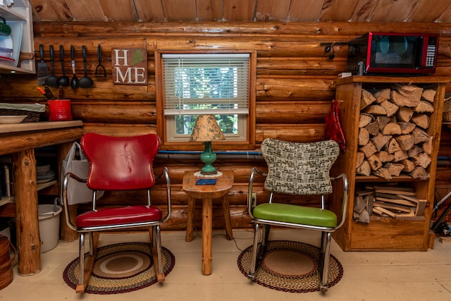 living area with wood ceiling and rustic walls