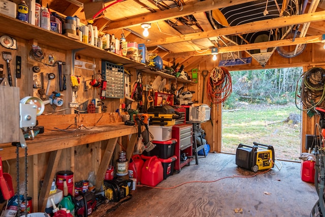 garage featuring a workshop area and wood walls