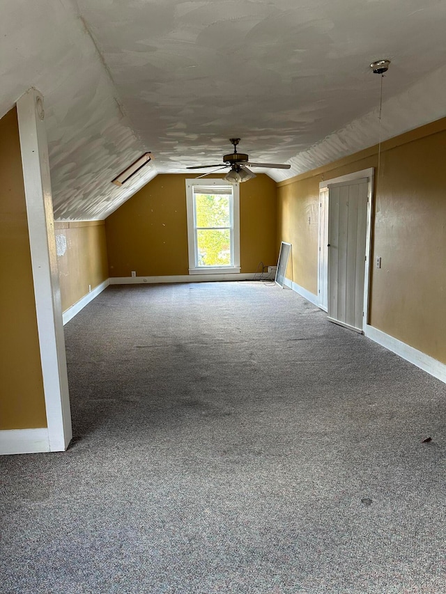 bonus room with carpet floors, ceiling fan, and vaulted ceiling