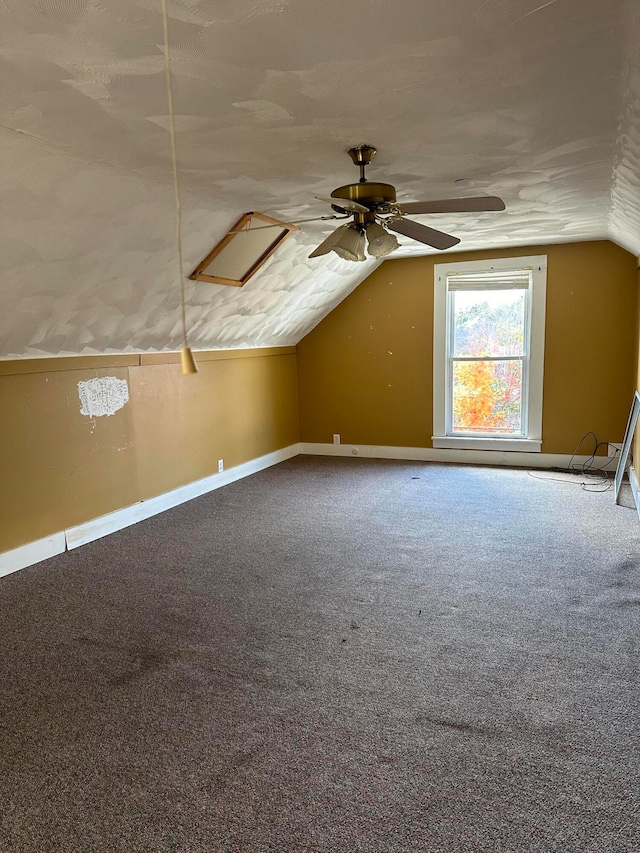 additional living space featuring ceiling fan, carpet, and vaulted ceiling