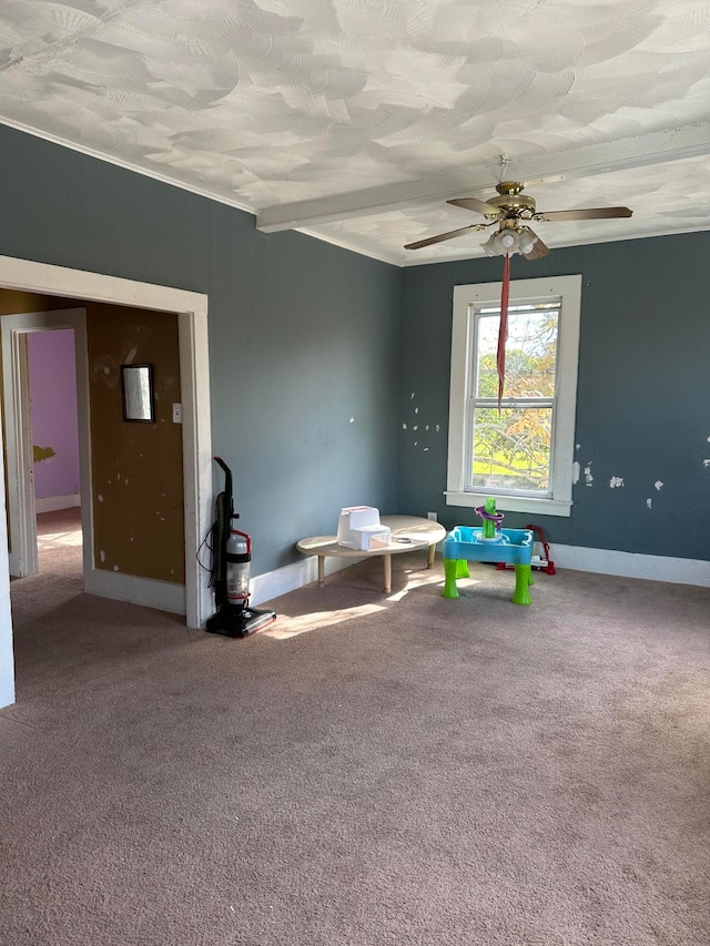 rec room with beamed ceiling, carpet, a textured ceiling, and ceiling fan