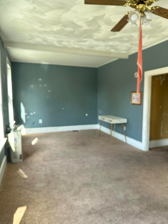 unfurnished living room featuring ceiling fan and carpet floors