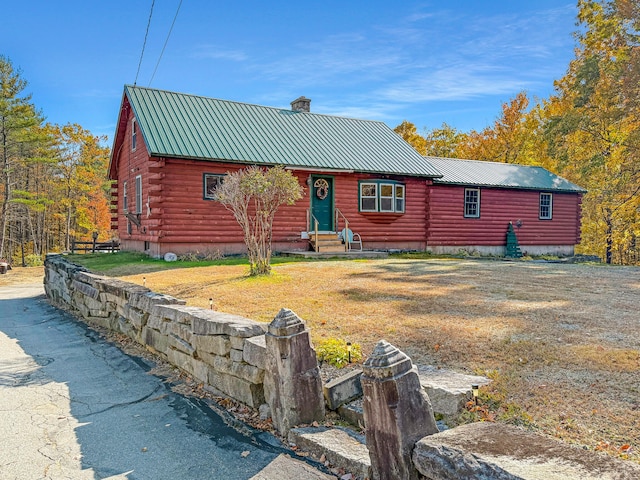 log-style house with a front yard