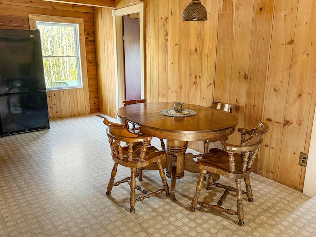 dining room with wooden walls