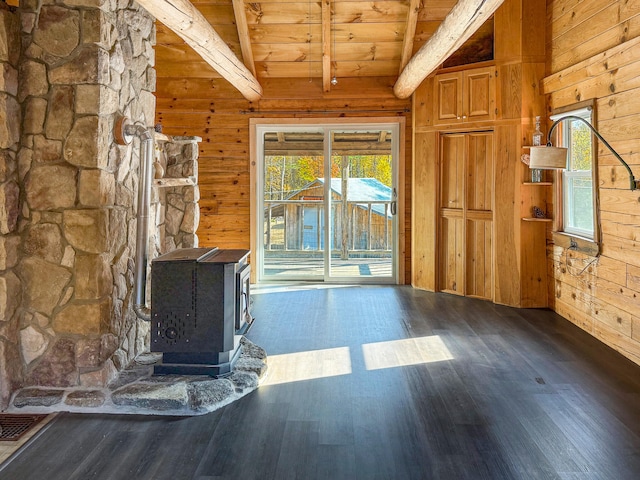 unfurnished living room featuring wooden ceiling, vaulted ceiling with beams, dark wood-type flooring, wooden walls, and a wood stove