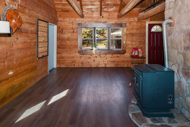 entrance foyer featuring wooden walls, wooden ceiling, a wood stove, dark hardwood / wood-style floors, and lofted ceiling with beams