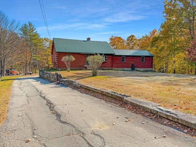 log-style house with a front lawn