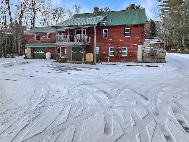 view of front of property with a balcony and a garage