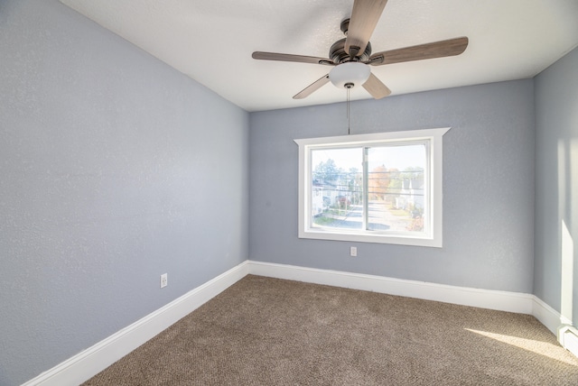 spare room featuring ceiling fan and carpet floors