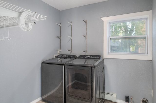 laundry room featuring a baseboard radiator and washing machine and clothes dryer